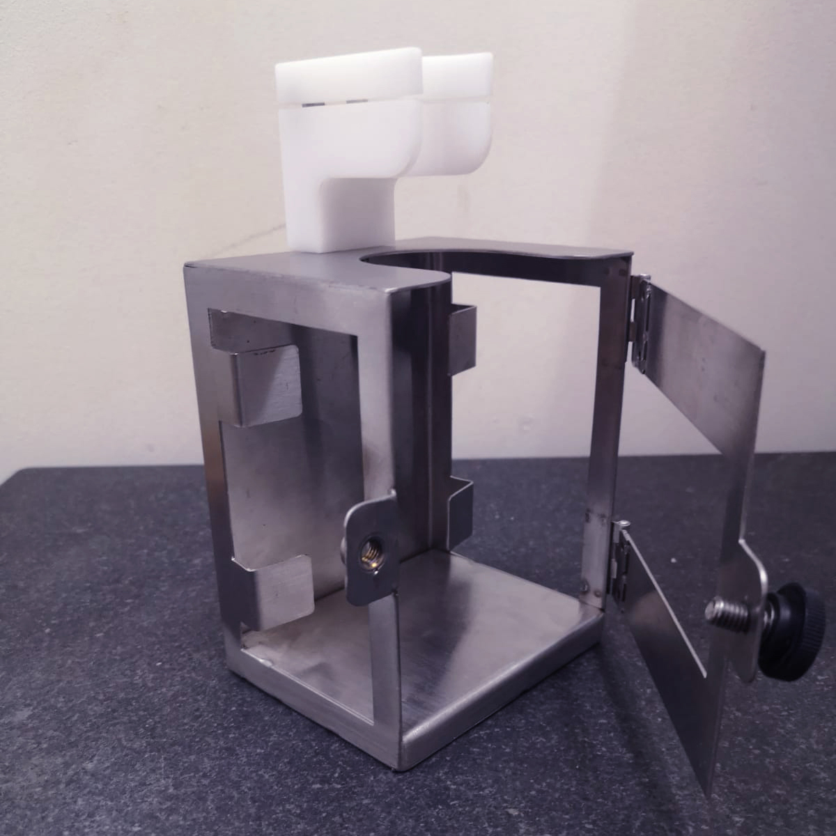 Stainless steel frame designed to fit a hand sanitiser bottle Stainless steel frame designed to fit a hand sanitiser bottle