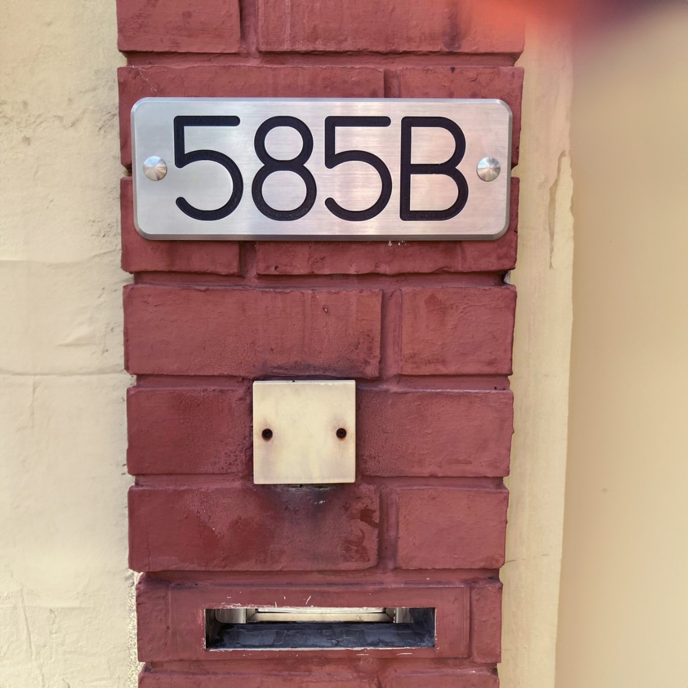 Stainless steel unit number plate outside a house Stainless steel unit number plate outside a house